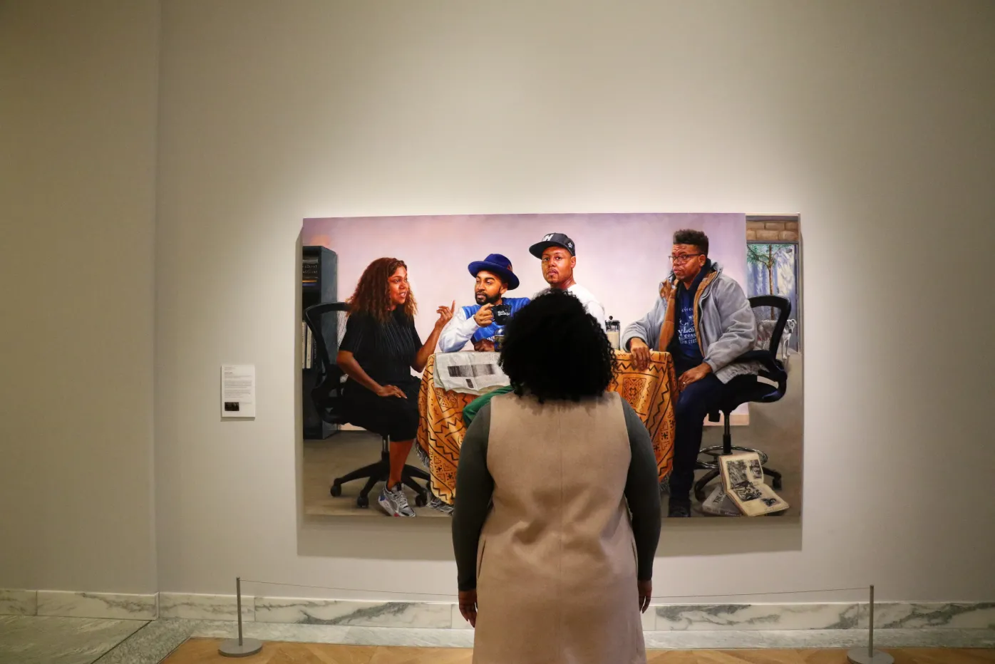 A visitor observes Mario Moore's "The Council," in the Detroit 幸运飞行艇168网官方查询记录历史结果 Institute of Arts' galleries.