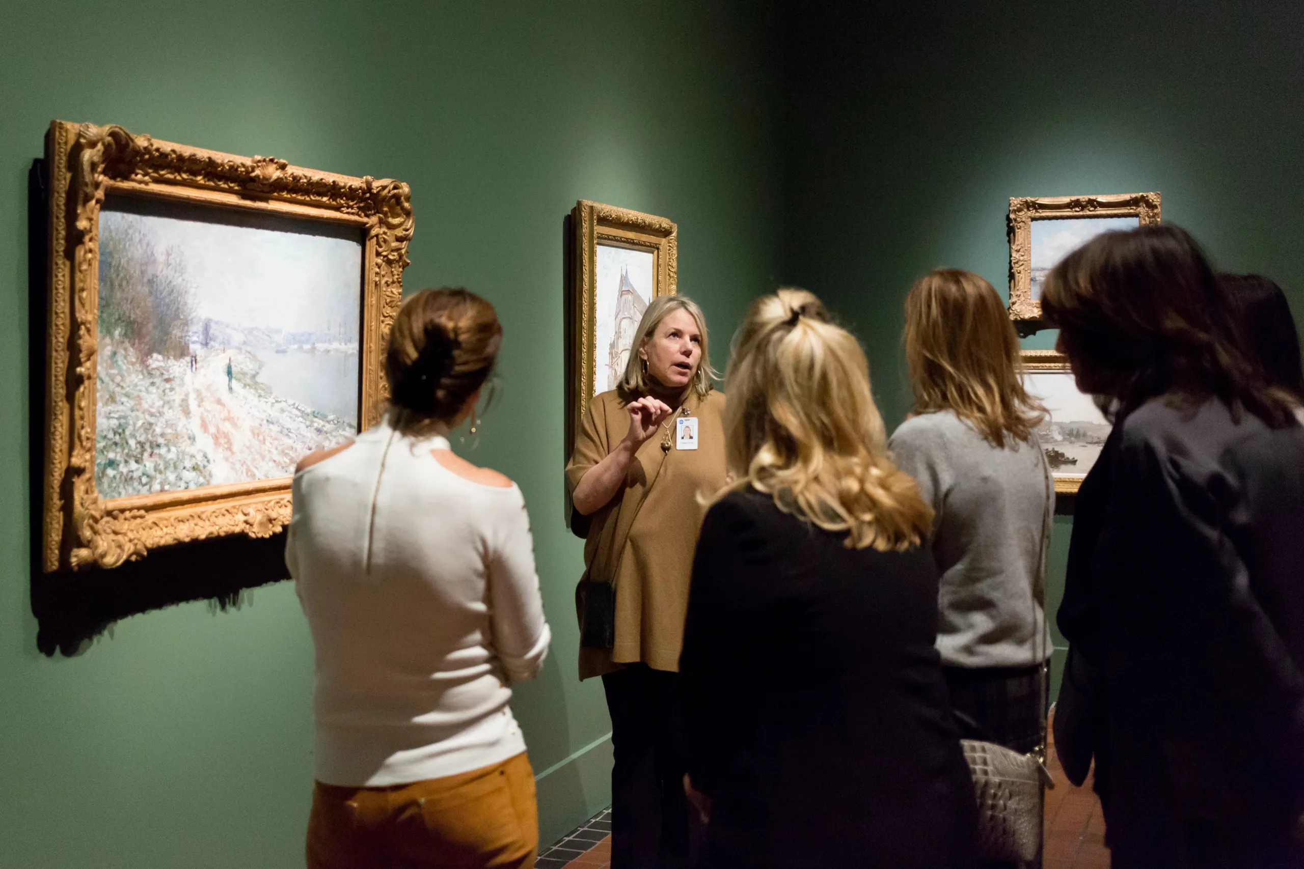 Group of adults touring a museum gallery.